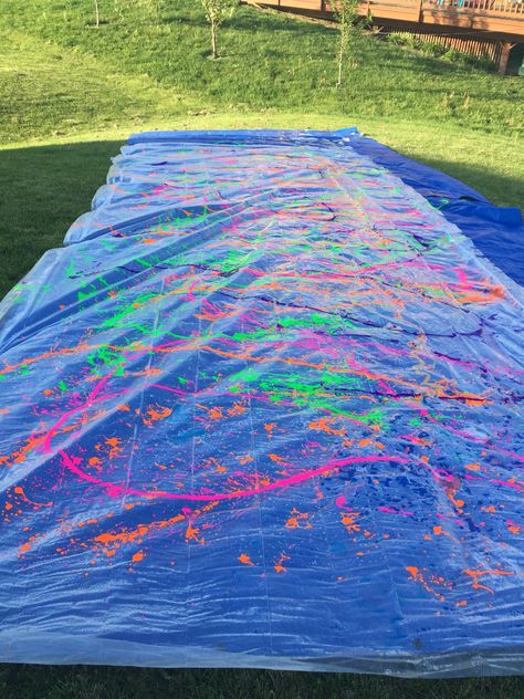 Paint slip and slide success! Water, dawn, and neon paint ! Neon Summer Party, Neon Outdoor Party, Glow In The Dark Slip And Slide, Neon Pool Party Ideas Summer, Neon Birthday Party Pool, Paint Slip And Slide Party, Neon Paint Party Ideas, Paint Slip And Slide, Neon Paint Party