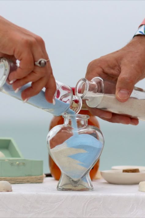 Unity Sand Jar Ceremony Wedding Ritual | Sarasota Florida Beach Wedding Service | Beach Wedding Planners | Florida Sun Weddings | Wedding Couple Pours Different Colored Sand into a Heart Shaped Jar | Wedding Memento | Beach Wedding Ideas Inspiration | Get Married on the Beach | Beach Wedding Ceremony Ideas | Blessign Shell Wedding Ritual Magenta Wedding Decorations, Sand Jar, Ariel Wedding, Magenta Wedding, Sand Ceremony Wedding, Wedding Ceremony Unity, Unity Sand Ceremony, Unity Sand, Vow Renewal Ceremony