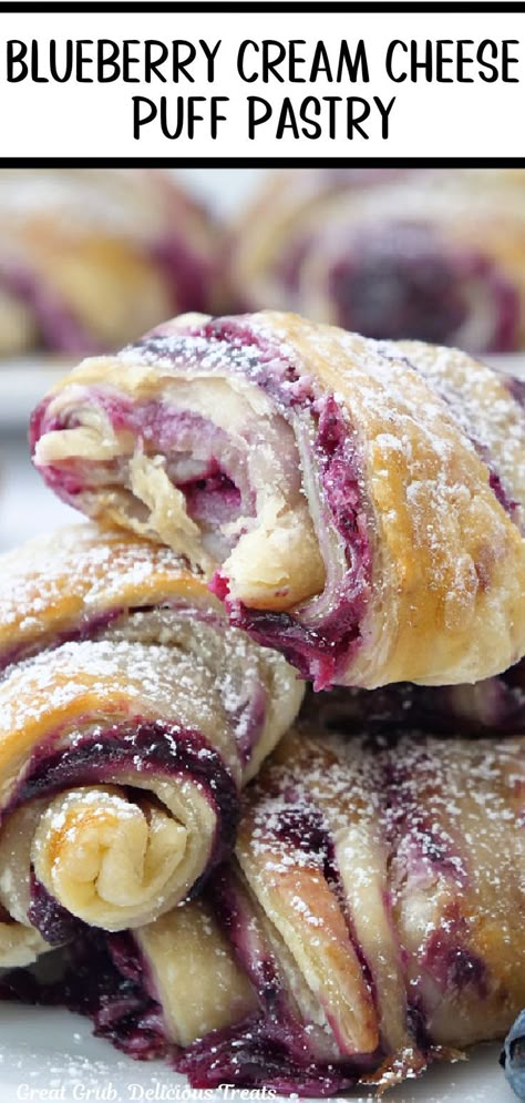 Three blueberry puff pastries dusted with powdered sugar on a plate with a bite taken out of the top one. Blueberry Cream Cheese Puff Pastry, Danish Recipe Puff Pastry, Blueberry Puff Pastry, Sweet Puff Pastry Recipes, Cream Cheese Puffs, Easy Puff Pastry Recipe, Puff Pastry Recipes Dessert, Pastry Dough Recipe, Cream Cheese Puff Pastry