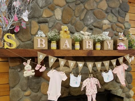 A baby shower clothesline  with adorable baby clothes Clothesline Baby Shower Decor, Baby Shower Clothes Line, Shower Clothes Line, Baby Shower Clothesline, Baby Shower Decorating Ideas, Shower Clothes, Baby Shower Clothes, Bow Baby Shower, Baby Shower Theme Decorations