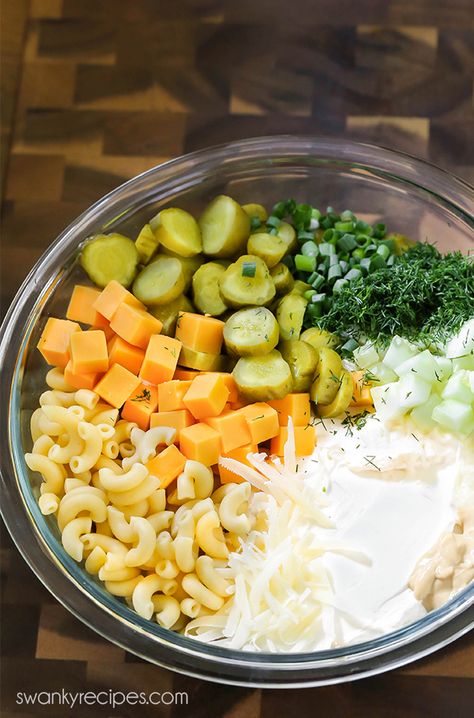 Pickle salad ingredients in a mixing bowl. Sour cream, mayo, sliced dill pickles, cucumbers, mustard, diced sharp cheddar cheese, cold pasta, and green onions. Traditional Pasta Salad, Summer Macaroni Salad, Pickles Cucumbers, Pickle Salad, Pickle Pasta Salad, Pickle Pasta, Dill Pickle Pasta Salad, Macaroni Salads, Current Recipes