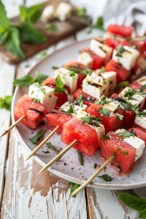 Watermelon and feta cheese skewers garnished with mint leaves on a white plate. Watermelon Feta Mint Salad, Cheesy Spinach Artichoke Dip, Salad Skewers, Lavender Scones, Roasted Cauliflower Steaks, Buffalo Cauliflower Bites, Easy To Make Appetizers, Mint Salad, Watermelon And Feta