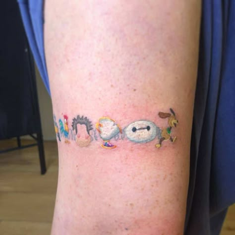 Small Cute Disney Tattoos courtenaydicksontattoo Disney Arm Band Tattoo, Funko Pop Tattoo Ideas, Small World Tattoo Disney, Best Disney Tattoos, Disney Movie Inspired Tattoos, Disney Forearm Tattoo Women, Small Pixar Tattoos, Disney Wrap Around Tattoo, Disney Bracelet Tattoo