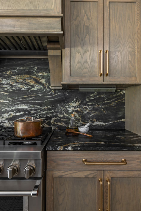 Interior Design by A. Lantz Design / Lantz Collective Photography & Styling by The Home Aesthetic  #home #inspo #interiors #homedecor #lifestyle #homeremodel #transitional #design #lifestyle #miswest #luxury #luxuryliving #trending #interiordesign #interiordesigner #lantzcollective #kitchen #kitchendesign #dark #countertop #stone #lightwood #cabinetry #appliances #faucet #farmsink #pantry #scullery #chefskitchen #hardware #marble #backsplash #range #hood #oven #stove Moody Transitional Kitchen, Black Diamond Quartzite Countertops, Skullery Kitchen, Dark Stone Countertops, Contempary Kitchen, Backsplash Range Hood, Faucet Over Stove, Pantry Scullery, Full Height Backsplash