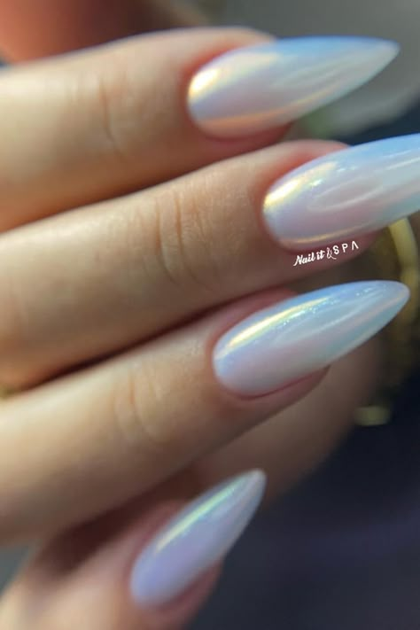 These almond-shaped nails are simply mesmerizing with their opalescent finish that catches the light with a holographic effect. The sheer and subtle luminosity offers an understated yet chic look perfect for any occasion. They're a dreamy twist to a minimalist manicure, reflecting an ethereal rainbow sheen that’s both modern and sophisticated. ✨  // Photo Credit: Instagram @nail.it.spa Iridescent Nails Almond Shape, Nail Ideas Iridescent, Galaxy Almond Nails, Opalite Nails, Iridescent French Nails, Opal Almond Nails, Holographic Nails French Tip, Subtle Rainbow Nails, Irredecent Nail Designs