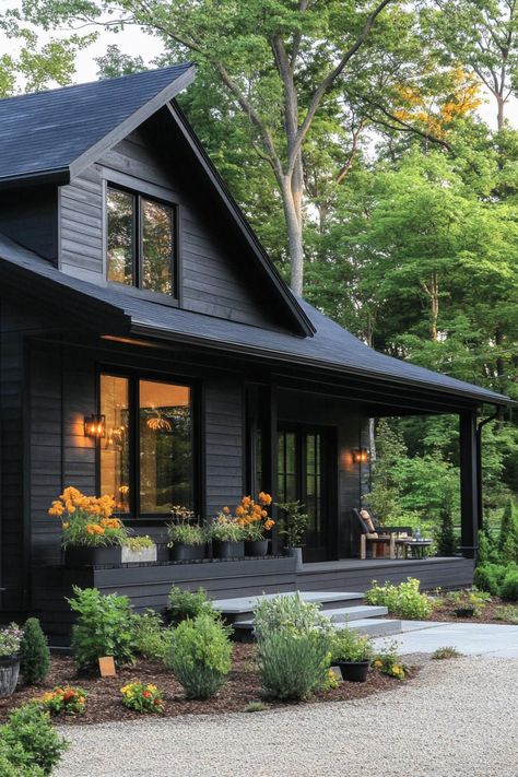 Dark wooden house with large windows surrounded by lush greenery. These Scandinavian modern houses are a hug of architecture — a sleek, nordic sanctuary with a dash of whimsy. Black House With Wood Accents, House With Large Windows, Scandinavian Modern House, Forest Houses, Stone Chimney, Wooden Facade, Hillside House, Suburban House, Wood Cladding