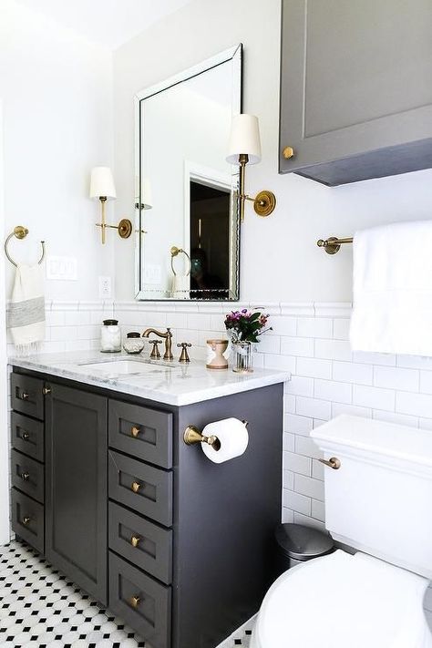 Wonderfully designed black and white bathroom boasts a black bath vanity placed on black and white vintage floor tiles and fitted with brass hardware and a white and gray marble countertop. White Marble Countertops Bathroom, Marble Countertops Bathroom, Half Bathroom Remodel, Gray And White Bathroom, Bad Inspiration, Black And White Tiles, Classic Bathroom, White Marble Countertops, Trendy Bathroom