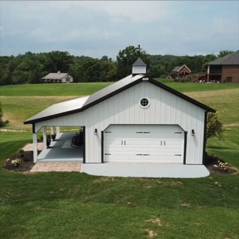 This 24' x 30' Pole Barn Garage is our most popular project. This garage makes a perfect addition to any country lot. The post frame design ensures a long-lasting addition to your estate and our steel panels ensure lifelong beauty with minimal maintenance. Whether it is used for storage or insulated for a workshop, she-shed or man-cave, this backyard garage is sure to please any homeowner. Click on the link to see the current price. 30 X 30 Garage Plans, 24x30 Garage Plans, Backyard Garage Ideas, Pole Barn Garage Interior, White Pole Barn, Pole Barn With Porch, 30x40 Pole Barn Garage, Steel Building Garage, Metal Garage Ideas