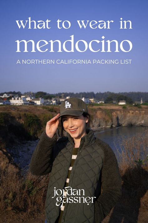 The text, "What To Wear in Mendocino: A Northern California Packing List" overlaying a photo of Travel Blogger Jordan Gassner smiling and adjusting her baseball cap on top of the cliffside in front of the town of Mendocino, California California Vacation Outfits, Northern California Beaches, Northern California Road Trip, Northern California Travel, Fort Bragg California, Northern California Coast, Mendocino California, Coast Outfit, Mendocino Coast