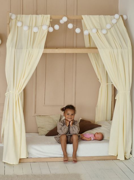 This Vanilla-colored muslin canopy adds a touch of elegance and comfort to your little one's haven. Crafted from organic, breathable muslin fabric, it's a gentle addition to their sleep environment. Choose between single or pair options, each with a width of 130 cm (51 inches). he cover in the main picture is 3.8 meters long, bringing a soothing touch to your child's space. Our house bed dimensions are 55.1"L x 31.4"W x 70.86"H. Elevate their sleep with Montessori-inspired aesthetics. Toddler Canopy Bed Ideas, Toddler Girls Bed, Toddler Canopy Bed, Toddler Bed Girl, Montessori House Bed, Space Kids Room, Toddler House Bed, House Beds For Kids, Montessori Bed