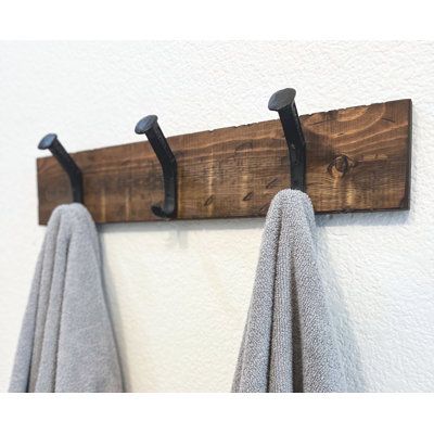 Our Farmhouse Towel or Coat Hanger is a designed to blend great functionality with classic rustic design. We start with recycled blue pine which are pine trees from the Rocky mountains that have died and create a beautiful mix of greys and blues. We purchase the material unfinished and create an aged look using chains, hammers, and other tools to create an amazing aged look and feel. Cast iron railroad spikes are sturdy and protected for use in damp environments. All sizes come fully assembled a Farmhouse Towel Rack, Rustic Toilet Paper Holders, Wall Towel Racks, Mounted Towel Rack, Montana House, Renovated House, Wall Shelf With Hooks, Rustic Toilets, Toilet Paper Holder Wall