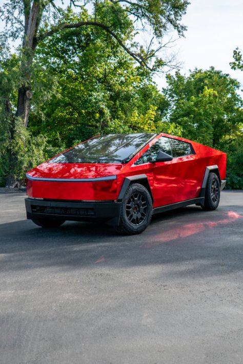 Red chrome Cybertruck with a green foliage behind it. Custom Cybertruck, Cybertruck Wrap, Red Chrome, Tesla Cybertruck, Vehicle Wraps, Fast Car, Red Vinyl, Color Rojo, Car Wrap