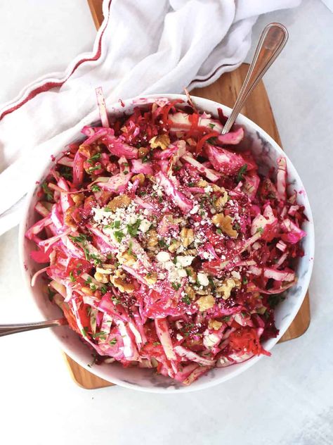 This crunchy beet slaw is made with raw beetroot, carrot and cabbage and tossed in a sweet and tangy orange dressing. Crumbled feta and walnuts add texture and flavor to this colorful salad. Perfect for a topping for tacos, this easy recipe can be made ahead of time and comes together in minutes. Roasted Canned Potatoes, Beet Slaw, Orange Dressing, Carrot Slaw, Canned Potatoes, Raw Beets, Slaw Recipe, Beetroot Salad, Pickled Beets