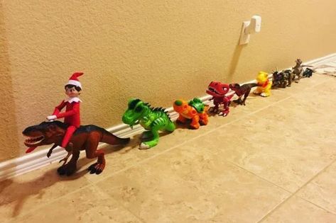 Get the kids or your nieces and nephews to create this dino train with the elf as the hero character. Making it is a breeze. Just line up the kids’ dinosaur toys in a row, with the largest one at the front. Source: Pinterest (@Erin Wolfe) #ElfOnTheShelfIdeas #HolidayElfFun #ElfMischief #CreativeElfScenarios #ChristmasElfPranks #ElfAdventures #ElfOnTheShelfActivities #FamilyElfTraditions #ElfAntics #ElfPoses Elf On The Shelf Partner Ideas, Elf On Shelf With Dinosaurs, Elf On The Shelf Gifts From Santa, Toddler Boy Elf On The Shelf Ideas, Elf On The Shelf Ideas With Toys, Elf On The Shelf Ideas Hot Wheels, Elf On Shelf Dinosaur, Elf With Dinosaurs, Elf On The Shelf With Toys