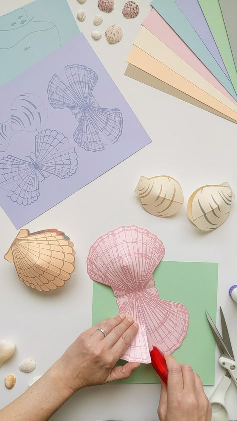 [object Object]... How To Make Sea Shells Out Of Paper, Seashell Paper Crafts, Diy Clam Shell Crafts, Shell Template Free Printable, Diy Ocean Decorations, Origami Seashell, Mermaid Template Free Printable, Diy Clam Shell, Clam Craft