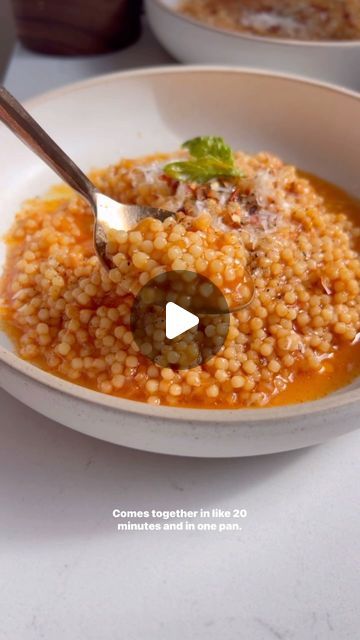 Nadia Aidi on Instagram: "Tomato Pastina 🍅(Acini Di Pepe)…so cozy, comes together in one pan in 20 min! Everyone in my family was a fan 🫶🏻.

Tip: don’t be scared of the soy sauce/tamari or balsamic…they balance it out so nice! Also make sure your stock is also boiling hot!

Ingredients:
•1 cup acini di pepe.
•1 shallot (chopped).
•1 garlic clove (grated).
•4.5 chicken or veggie stock (hot or boiling).
•1/4 cup + 1 tbsp good tomato paste.
•1 tbsp tamari OR soy sauce.
•1 tbsp balsamic vin.
•10 basil leaves.
•1 cup grated parmigiano reggiano (more for topping).
•salt/pepper to taste.
•good olive oil.
•crushed red peppers.

Directions:
1. Add some oil to a pan, and toast the pasta for 2 min until slightly golden on medium high with the shallots. Add in garlic and tomato paste, sautee 3 min Tomato Pastina, Everyone In My Family, Gumbo Soup, School Dinner, Quick Pasta, Veggie Stock, Garlic Clove, Taste Made, One Pot Pasta