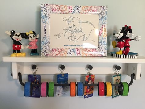 Disney Magic Bands displayed on a shelf from IKEA. Disney Magic Band Display, Magic Band Display, Disney Display, Disney Decorations, Disney Craft, Disney Room, Ikea Frame, Disney Room Decor, Disney Bedrooms