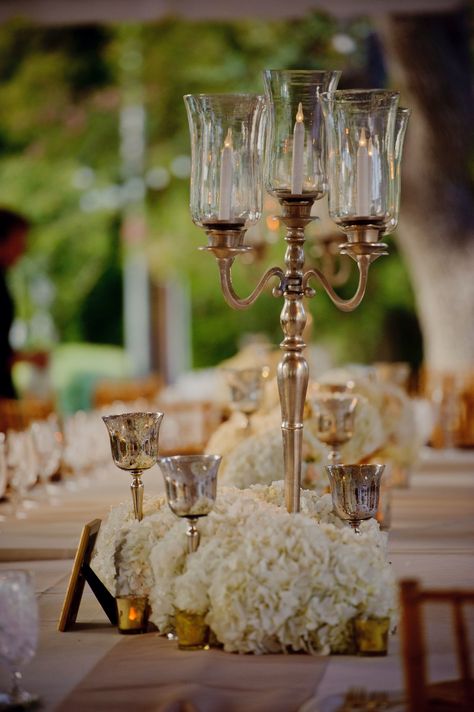 Medium centerpiece idea: silver candelabra with taper candles surrounded by mercury glass goblets filled with white hydrangeas and mercury glass votives. Tall Candles, Gold Candelabra, Candelabra Wedding, Flowers And Candles, Silver Candelabra, Candlestick Centerpiece, Candelabra Centerpiece, Nola Wedding, Idea Photo