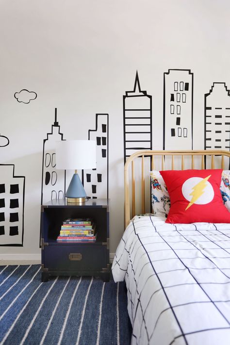 Kids’ bedrooms are super cool. That’s because you can do super fun things with them—like pull off a superhero theme. Which is exactly what we did for this little client’s first big-boy room. Let’s get into it! Subtle Superhero Bedroom, Spidey Bedroom Ideas, Vintage Superhero Bedroom, Boys Room Design Small Bedrooms, Boy Superhero Bedroom, Spiderman Room Aesthetic, Superhero Bedroom Boys, Modern Superhero Bedroom, Comic Themed Room