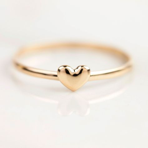 Sweet and dainty tiny heart ring is perfect for an everyday ring as it is so delicate and simple. Available in 14K solid gold in yellow, rose, or white. Can be stacked with all your favorite rings. Purchase one for yourself or express your love with this charming ring for your special partner or friends. This simple ring will make a lovely gift for birthdays, anniversaries or Mother's Day.  * This ring is currently in size 7 for immediate shipping. * Re-sizable to 3-7.5 and takes 10 business days. * Heart width x height: ≈5mm x ≈4mm * Band height: ≈1.3mm * Made of 100% recycled precious metal * Comes in a gift box with a bow ready for gifting * Handmade with love and great care in New York Small Heart Ring, Friend Rings, Couple Wedding Rings, Kids Rings, Everyday Ring, Simple Ring, Gift Love, Everyday Rings, Tiny Heart