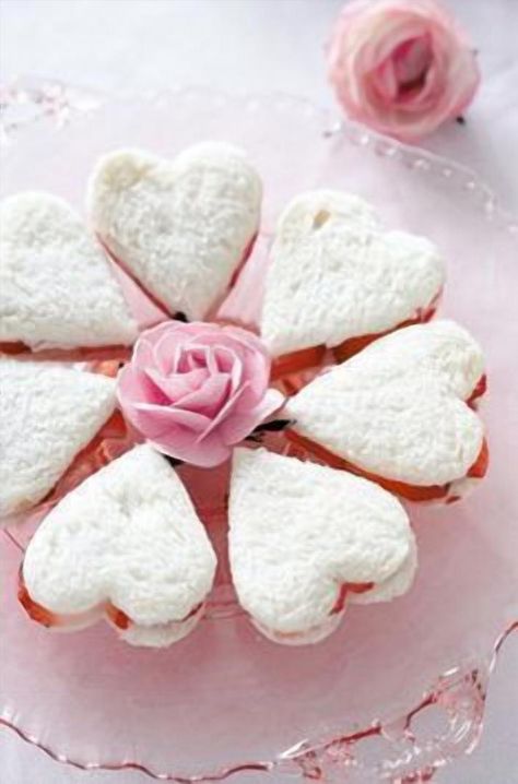 Transform your next tea party or bridal shower into a delightful affair with these charming heart-shaped sandwiches. Perfectly crafted to add a touch of whimsy and elegance, these sandwiches are as delicious as they are adorable. Whether you're serving a classic cucumber and cream cheese or a savory smoked salmon filling, these bite-sized treats are sure to impress your guests. Easy to make and irresistibly cute, they are the perfect addition to your celebration spread. Get ready to win hearts and create unforgettable memories with these lovely little sandwiches. Tartiflette Recipe, Valentines Tea Party, Tea Sandwich, Tea Party Sandwiches, Tea Sandwiches Recipes, Valentine Tea, Party Sandwiches, Princess Tea Party, High Tea Party