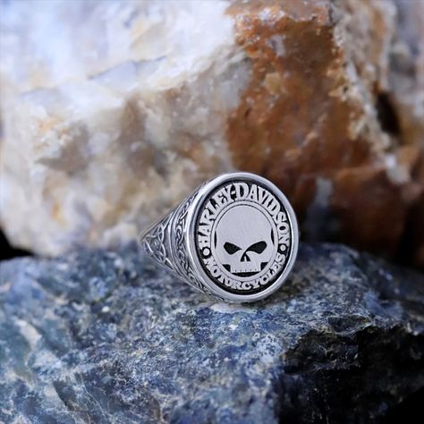 This Harley Davidson skull biker ring is a unique and eye-catching piece of handmade jewelry. Made from high-quality 925 sterling silver, this chunky statement ring is the perfect accessory for any man who loves motorcycles and wants to make a bold statement. #WomenRing #MenRing #SignetRing #SilverRing #ChunkyRing #SkullRing #HarleyDavidson #DavidsonRing #PinkyRing #MotorcycleRing #BikerRing #HandmadeJewelry #AnniversaryGift Skull Signet Ring, Luxury Handmade Silver Skull Ring, Harley Davidson Rings, Silver Skull Biker Jewelry, Sterling Silver Skull Ring Hallmarked, Luxury Hallmarked Sterling Silver Skull Ring, Biker Rings, Chunky Rings, Skull Ring