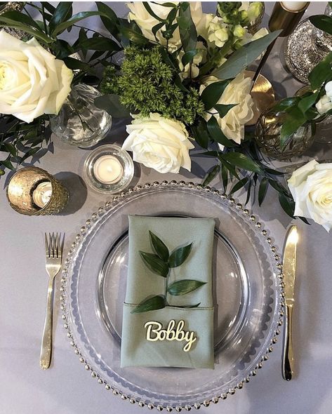 Layered mid tones of grey and sage green and lifted with neutral florals and candlelight to create this beautiful tablescape. Designed by Ambience York at Bunny Hill, York.  Table Decor | Wedding Table Decor | Place Setting | Charger Plates | Colour Palette | Sage Green | Grey | Wedding Decor | Wedding Decorations | Neutral Florals | Tablescape | Wedding Tablescape | Wedding Table Inspiration | Wedding Reception | Wedding Reception Decor Table Settings Sage Green, Industrial Wedding Table, Wedding Plate Setting, Green Table Settings, Grey Wedding Decor, Wedding Table Place Settings, Green Tablescape, Sage Green Wedding Colors, Round Wedding Tables