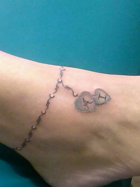 I want something similar to this but with 2 charms and names of my girls with their birth dates. Maybe? Charm Anklet Tattoo, Charm Bracelet Tattoo, Tattoo Ankle, Ankle Tat, Rosary Tattoo, Ankle Bracelet Tattoo, Ankle Tattoo Designs, Tattoos With Kids Names, Anklet Tattoos