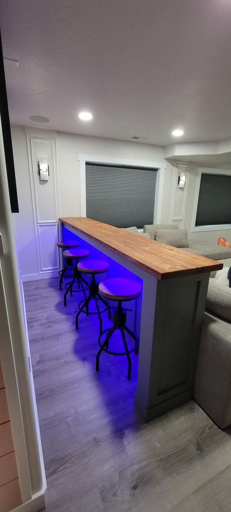 Floating Bar Shelf With Stools, Bar Ledge On Wall With Stools, Bar Room Wall Ideas, Basement Bar Stool Ideas, Neon Basement Ideas, Diy Bar Behind Couch, Basement Bar Behind Couch, Basement Counter Bar, Led Lights Behind Couch