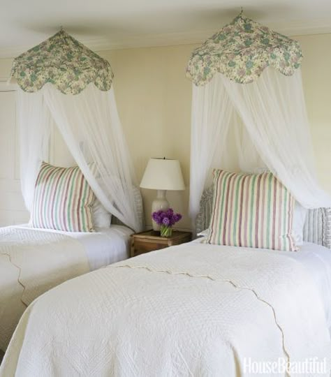 Wicker twin beds in a guest bedroom are topped with mosquito-net canopies in Ireland's Roses linen in Pistachio. Throw pillows are covered in her Ithaca linen in Mauve/Lavender/Pistachio. Click through for more pictures of Jackie Kennedy's beach house. Cape Cod Vacation, Beautiful Beds, Twin Beds, Twin Bedroom, Cape Cod House, Shabby Chic Bedroom, Yellow Bedroom, Dream Cottage, Shabby Chic Bedrooms