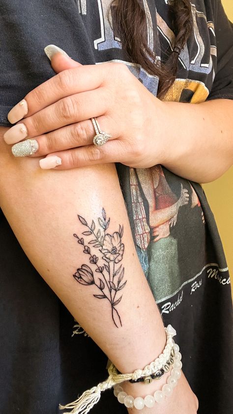 Black and gray simple wildflower tattoo on forearm Flower And Greenery Tattoo, You Belong Among The Wildflowers Tattoo, Greenery Tattoos, Wildflower Tattoo Forearm, Greenery Tattoo Sleeve, Greenery Tattoo, Front Thigh Tattoos, Floral Arm Tattoo, Floral Back Tattoos