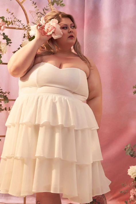 Meet Your New Bridal Staple - The Little White Dress A little white dress is often kinder to your wallet than a traditional gown.  More moolah for that honeymoon or those dream shoes!  ‍Who says looking fabulous has to break the bank? Bridal 2023, Traditional Gown, Modern Bridal Dress, Plus Size Summer Fashion, Layered Ruffle Dress, Traditional Gowns, Bridal Editorial, Plus Size Brides, Plus Size Fashion Tips