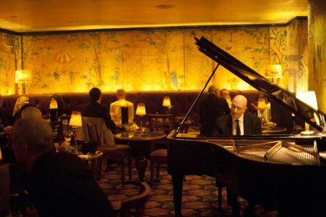 A piano player performs in a dimly lit, scenic wallpaper-wrapped dining area of Bemelmans Bar in New York City Bemelmans Bar, Ludlow Hotel, Carlyle Hotel, Nomad Hotel, Peninsula Hotel, Rosewood Hotel, Jazz Bar, New York Beauty, Piano Bar