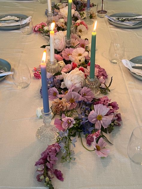 Pink purple blue pastel flower arrangement on dining table with candle sticks and blue ceramic dinner set for birthday dinner party Floral Party Table Decor, Flower Aesthetic Birthday Party, Maximalist Table Decor, Flower Themed Party Aesthetic, Circle Table Set Up, 18th Birthday Flower Decorations, Flowers Laying On Table, Floral Dinner Table Setting, Flower Dinner Party Aesthetic