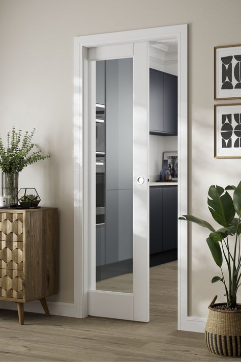 Create a bright and spacious feel by selecting this glazed door. The interiors glass door makes the most of natural light. A sliding door or pocket door is a great way to connect spaces together without making a room feel crowded. The clear, toughened glass of this white doors lets light stream through, whilst the slim border of the white interiors door offers a minimal look that will suit contemporary interiors. The internal door can also be made into a sliding door using a track. Howdens Internal Doors White, Glazed Sliding Doors Internal, Half Glass Pocket Door, Modern Sliding Glass Doors Interior, Single Sliding Doors Internal, Invisible Sliding Doors Interior, Sliding Pocket Doors Internal, Connecting Door Ideas, Glazed Internal Doors Hallway