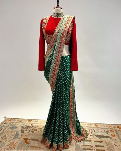 NIDHI TAMBI KEJRIWAL on Instagram: "A Bottle green and Red Bandhej Saree in Marodi and gota work with a classic full sleeves blouse. For enquiries, orders and customisations, kindly connect with our teams over whatsapp at +91 8860558705 or +91 8591639131 or email us at info@nidhitambikejriwal.com For more info, visit www.nidhitambikejriwal.com #sharara #marodi #bandhej #bandhani #heritageclothing #nidhitambikejriwal #ntkdesigns" Green Bandhani Saree Blouse Design, Blouse Designs For Bandhani Sarees, Bandhej Saree Blouse Design, Bottle Green Blouse Designs, Green Bandhani Saree, Bottle Green Blouse, Full Sleeves Blouse, India Wedding Dress, Full Sleeves Blouse Designs