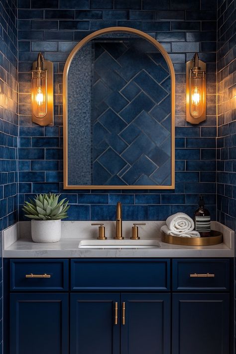 Transform your bathroom with these striking wall art ideas! Enhance your decor with rich blue tiles and warm lighting for a luxurious touch. Discover more chic design tips to elevate your space today! #BathroomDecor #InteriorDesign #WallArtIdeas Blue Bathroom With Gold Fixtures, Blue And Gold Bathroom Vanity, Bathroom Dark Blue Walls, Dark Blue Toilet Room, Guest Bathroom Ideas Blue, Navy Blue Tile Shower Ideas, Navy And Gold Bathroom Ideas, Blue Gold Bathroom Ideas, Dark Blue And Gold Bathroom