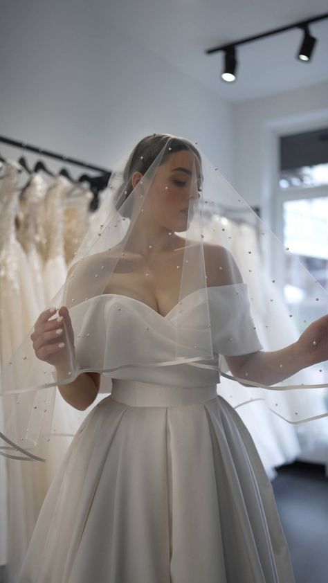 The double-layer bridal veil is made of soft and high-quality bridal tulle. The pearl veil is perfect for a classic, rustic, country, and boho wedding to create a beautiful and elegant look. You can choose one of many lengths according to your preferences.  Details: * Designed with pearls, satin ribbon and metal comb; * Length of the veil in the photos is 108 inches; * Color of the veil in the photos - light ivory; * The width of the satin ribbon is 0.3 inches and matches chosen color of the tul Veil With Ribbon Edge, Cathedral Veil With Satin Dress, Off Shoulder Wedding Dress Veil, Satin Trim Veil, Classic Wedding Veil, Elegant Bridal Veil, Satin Wedding Dress With Veil, Classic Satin Wedding Dress, Pearl Veil Wedding