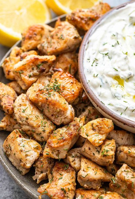 Greek chicken bites on a gray plate with a bowl of tzatziki on the plate. Greek Chicken Bites, Chicken Bites Oven, Greek Chicken Recipe, Boneless Skinless Chicken Breast Recipes, Skinless Chicken Breast Recipes, Mediterranean Dinner, Greek Chicken Recipes, Easy Mediterranean Diet Recipes, Favorite Recipes Chicken