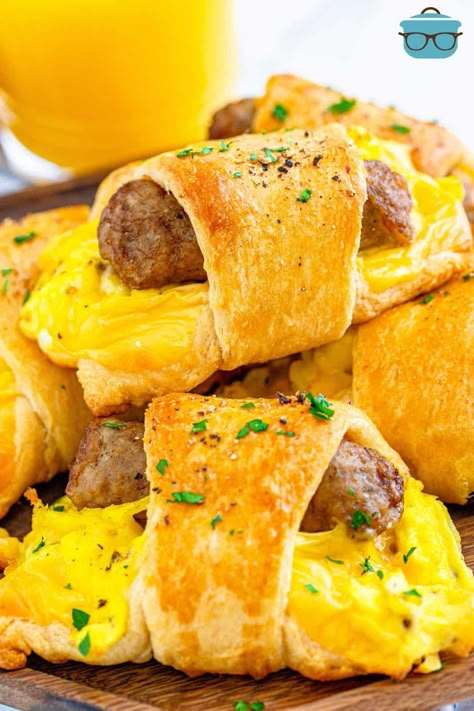 A stack of breakfast crescent rolls shown on a wooden serving plate with a glass of orange juice in the background. Crescent Breakfast, Eggs Cheese Breakfast, Vegetarian Nachos, Breakfast Sausage Links, Teacher Breakfast, Egg Benedict, Morning Meals, Breakfast Slider, Thanksgiving Breakfast