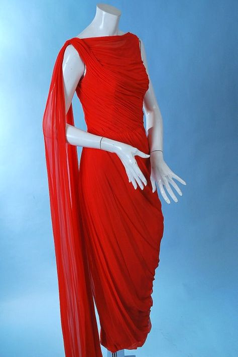 1950 Ceil Chapman Lady in Red Chiffon Gown. Masterful fluid draping of the silk chiffon to emphasize the curves of the female form, with cowl neckline, fan tail chiffon fluttering at the back. Lined in rayon crepe with stays through the bodice, back metal zipper, long chiffon streamer off one shoulder. Chapman Red, Ceil Chapman, Goddess Gown, Vintage Fashion 1950s, Fashion 1950s, Red Chiffon, Chiffon Gown, Cowl Neckline, Vintage Vogue