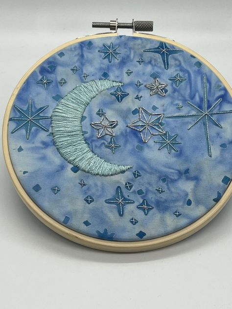 This is a 5 inch finished embroidered piece. It was stitched on batik fabric, with metallic thread.  The back is finished with a piece of felt. Winter Textiles, Nebula Embroidery, Embroidery On Dark Blue Fabric, Night Sky Embroidery Pattern, Embroidered Moon And Stars, Embroidered Night Sky, Moon Embroidery, Embroidery Decor, Simple Hand Embroidery Patterns