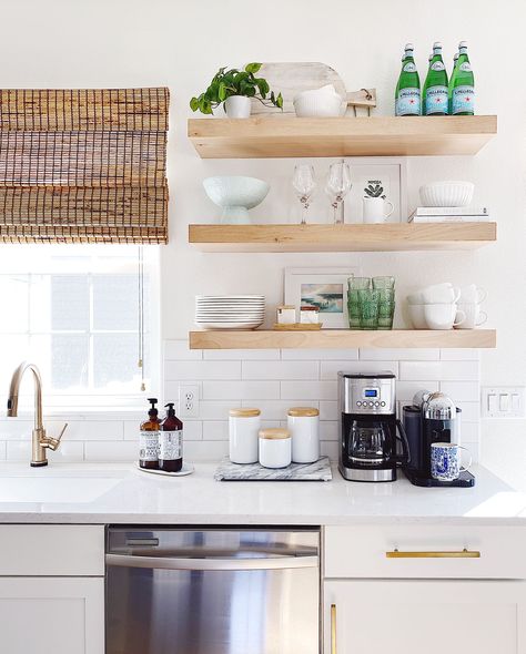 Open shelving in the kitchen with white and blue decor and gold faucet and cabinet hardware - jane at home #kitchendecor #kitchenideas #kitchendesign #home #style #decor Modern Coastal Kitchen, Coastal Kitchen Design, Coastal Kitchen Decor, Modern Coastal Decor, Beach House Kitchens, Coastal Kitchen, Spring Home Decor, Blue Decor, Spring Home