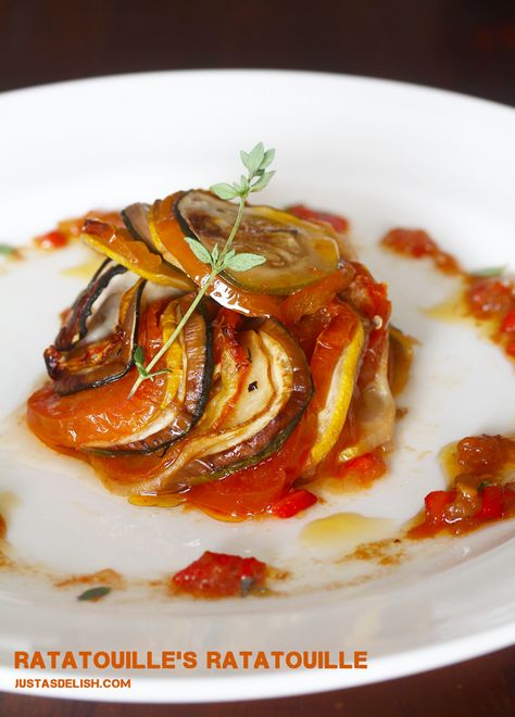 Ratatouille's Ratatouille (Thomas Keller's Confit Byaldi) This is oh so good! And it is generally how I cook eggplant, however, for my husband I use some marinara sauce instead of tomato slices. I could make a meal of this! Remys Ratatouille, Confit Byaldi, Pepper Puree, Cook Eggplant, Sliced Vegetables, Japanese Eggplant, Weekend Recipe, Yellow Zucchini, Green Zucchini