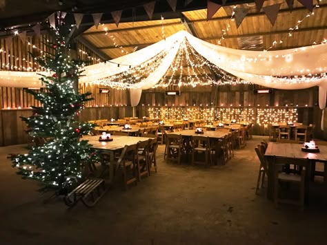 Merry Christmas form The Barn at South Milton, a rustic wedding venue in Devon! Perfectly decorated here for our annual Christmas Party, inspiration for a Christmas or winter wedding! Christmas Wedding Ceiling Decor, Christmas Party Venue Ideas, Christmas Party Venue Decorations, Christmas Venue Decorations, Warehouse Christmas Party Decor, Christmas Garage Party, Christmas Barn Wedding, Country Christmas Party, Christmas Venue