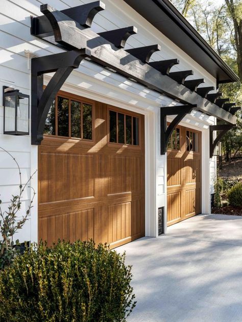 Garage With Walkway To House, Cedar Garage Door White House, White House With Stained Garage Doors, Garage Outside Design, Interior Door To Garage Entrance, Wooden Look Garage Doors, False Garage Door, White House Black Garage Door Wood Accents, Garage Entry Door To House