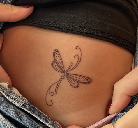 Womens Dragonfly Tattoo, Dragonfly Tattoo Hip, Rib Dragonfly Tattoo, Dragonfly Tattoo Tramp Stamp, Small Dragonfly Tattoo Placement, Side View Dragonfly Tattoo, Modern Tramp Stamp, Earthy Tattoos, Funky Tattoos