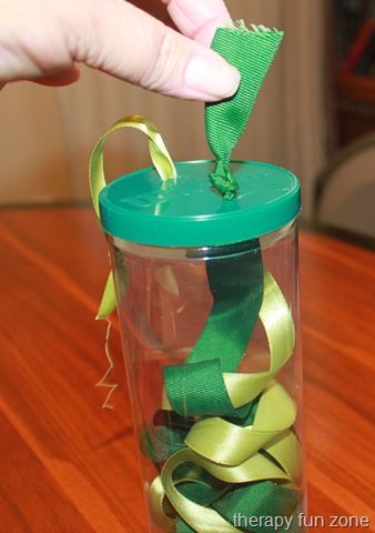 Pulling on small objects is great for working on fine motor skills, and what better small object to pull on than a ribbon. I had some tennis ball containers, and thought that the fact that they are see through would make it even more fun and motivating because you can see the ribbon moving inside the container. Pulling on the ribbon requires strength in the pincer grasp.  To make it, I just sliced holes in the lid, and tied the  {Read More} Daisy Activities, Playgroup Activities, Therapy Fun, Toddlers Activities, Infant Classroom, Fun Zone, Preschool Fine Motor, Daycare Ideas, Motor Skills Activities