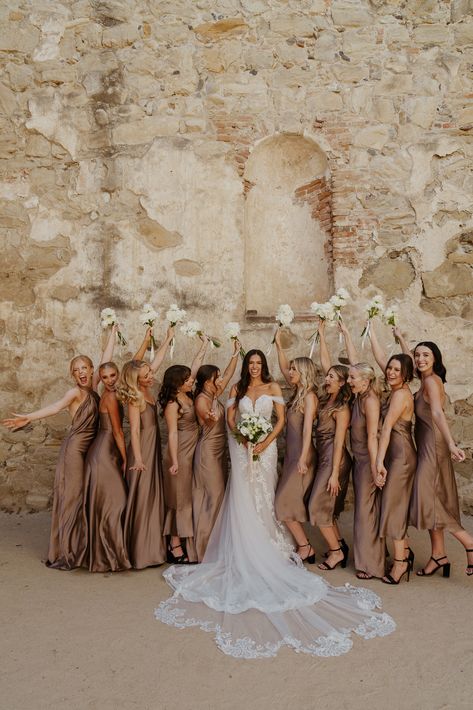 Bridal party photos at the San Juan Capistrano Mission September Wedding Champagne, Bridesmaid Dress Browns, Neutral Groomsmen Attire Color Palettes, Wedding Ideas Bridal Party, Wedding Reception Neutral Colors, White Champagne Wedding Color Schemes, Spring Bridal Party Attire, Taupe And Brown Wedding, Green And Champagne Wedding Party