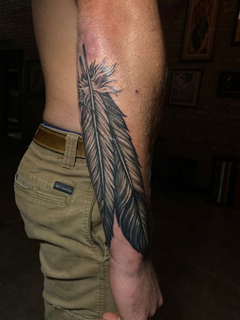 Mens Feather Tattoo Forearm, Men Feather Tattoo Ideas, Warrior Feather Tattoo, Mens Native Tattoos, Indian Arm Tattoo, Western Feather Tattoo Men, Country Neck Tattoo, Cowboy Tattoos For Men Forearm, Western Tattoos Forearm